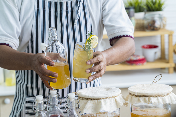 Persoon houd een fles en een glas in zijn hand